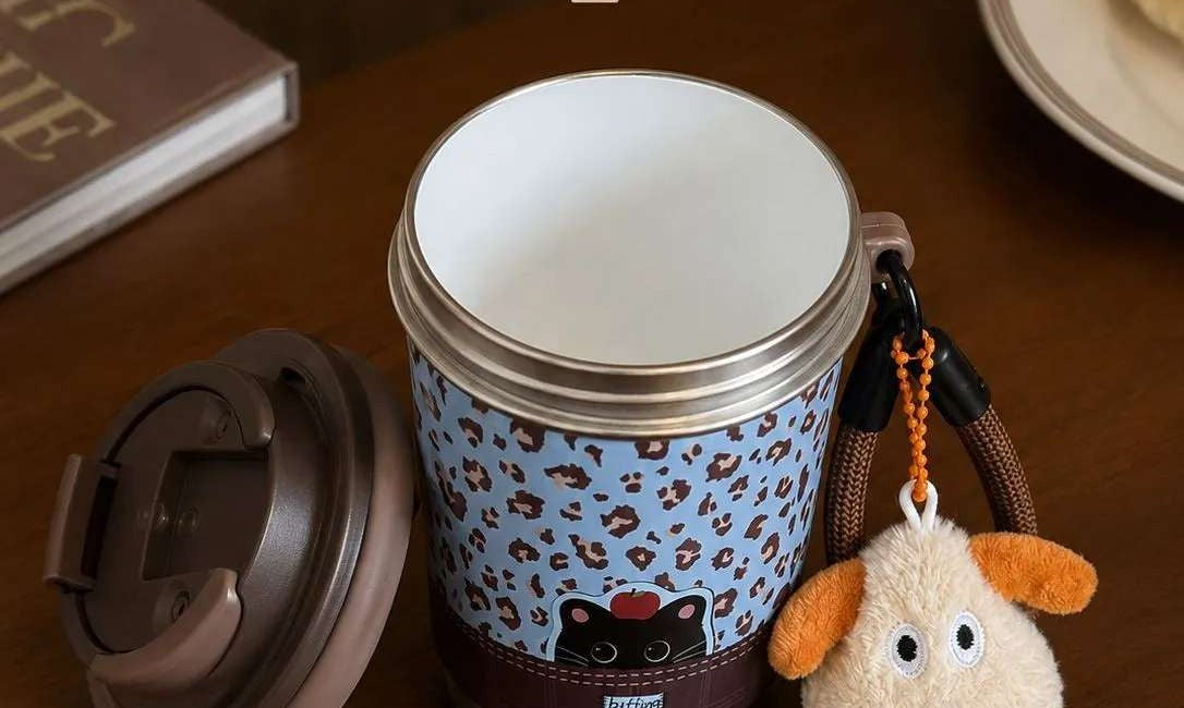 Cup shown open with lid removed, revealing the ceramic-coated inner tank